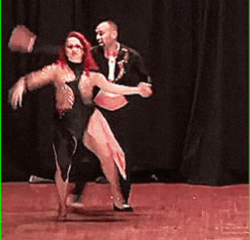 two people are on a stage dancing