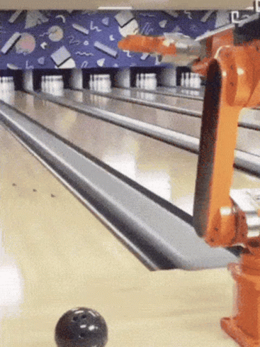a bowling alley with a ball flying towards the lanes