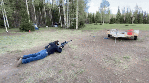 an image of a person laying down with a gun