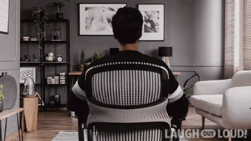 a person sits in a chair and watches tv
