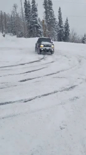 a truck in the snow on a snowy road