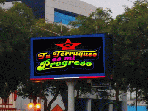 a neon sign for a restaurant in a foreign city