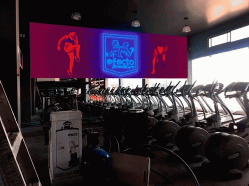 a fitness studio filled with different machines and equipment