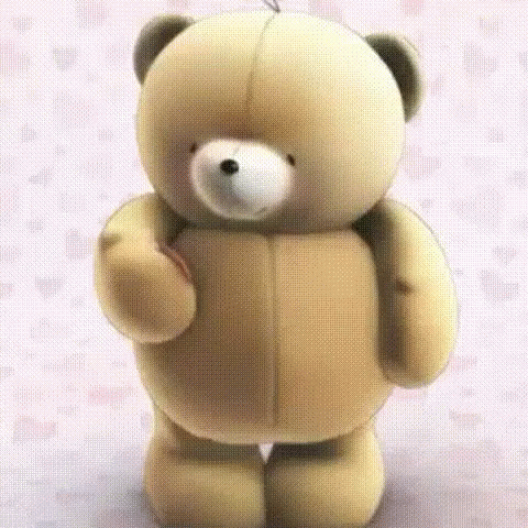 a small stuffed bear that is wearing soing blue