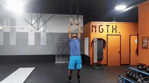 a person in a crossfit gym with ropes up