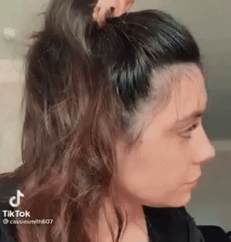 a person with long hair and a bow in their ear