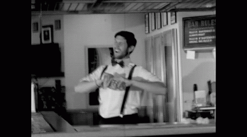 a man stands at the bar with his arms open