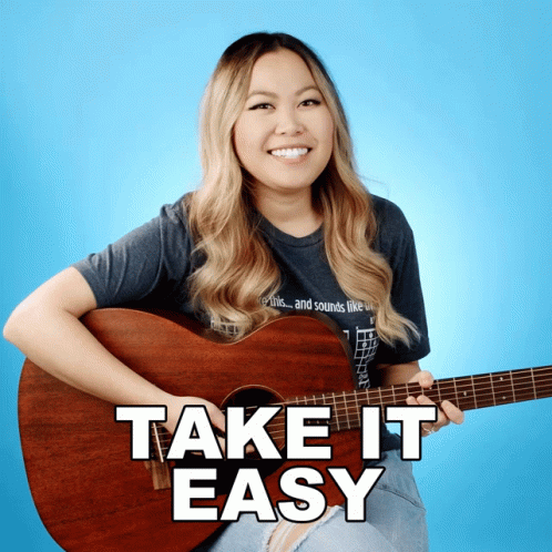 a girl is smiling and playing the guitar