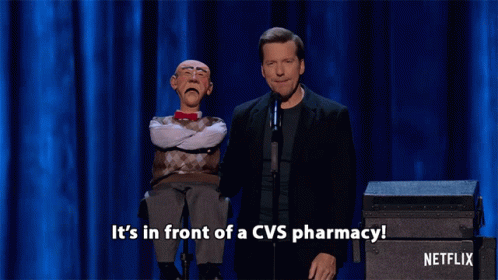 two male actors stand on stage in front of a podium with the words it's in front of a cvs pharmacy
