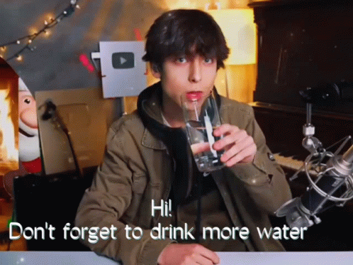 a man drinks from a drinking glass, while the text in the video says, don't forget to drink more water