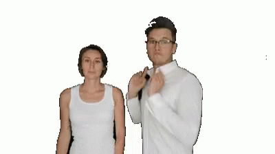two people wearing white are standing in front of a white backdrop