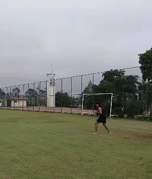 a person on an empty soccer field playing soccer