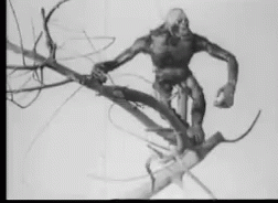a black and white pograph of a creepy zombie climbing