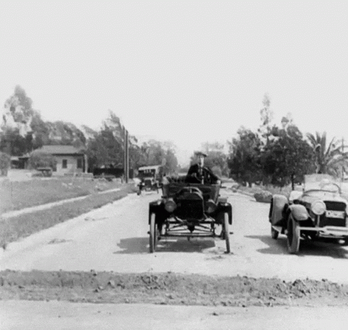 a vintage po shows a man driving a car on the road