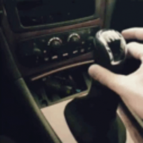 a person holds the steering wheel  in a car
