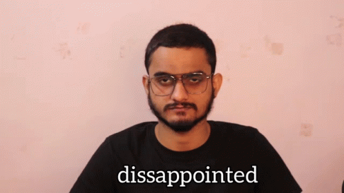a man with glasses and a black shirt has the word disapponited written in front of him
