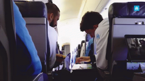 passengers sit in empty planes on their cell phones