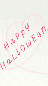 a happy halloween message is drawn in the air on a paper