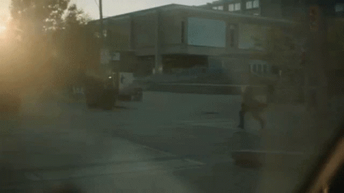the person is riding their skateboard in front of a building