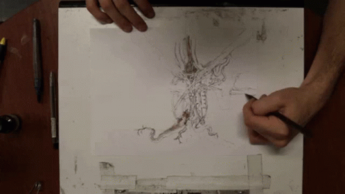 a drawing board with a pen and drawing on it
