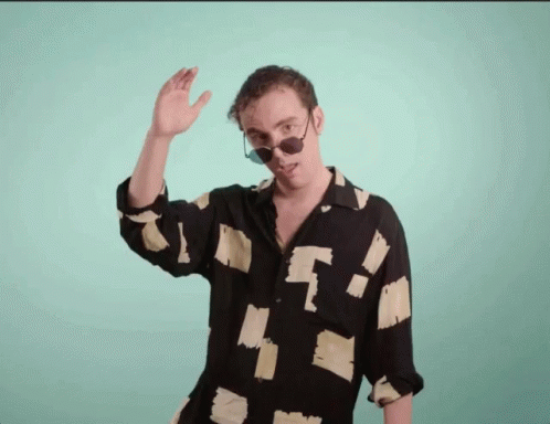 a man is making an odd gesture while wearing sunglasses