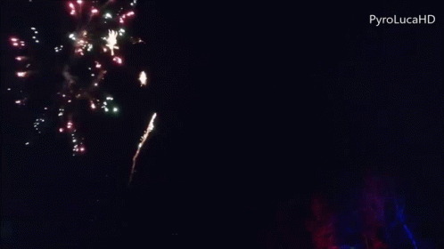 two colorful fireworks and blurry black background