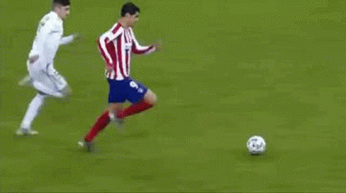 a couple of men kicking around a soccer ball