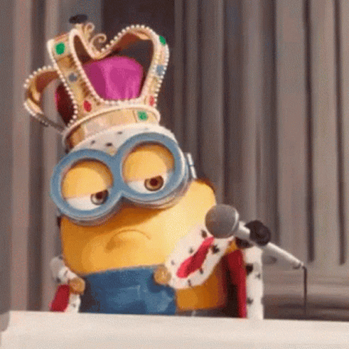 an odd minion is holding a microphone