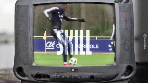 an old television that has a woman kicking a ball on the screen