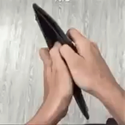 a person using a cell phone while writing