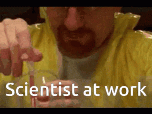 a man holding a cell phone while sitting next to a white text that reads, scientist at work