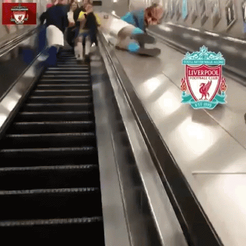 a group of people are riding down an escalator