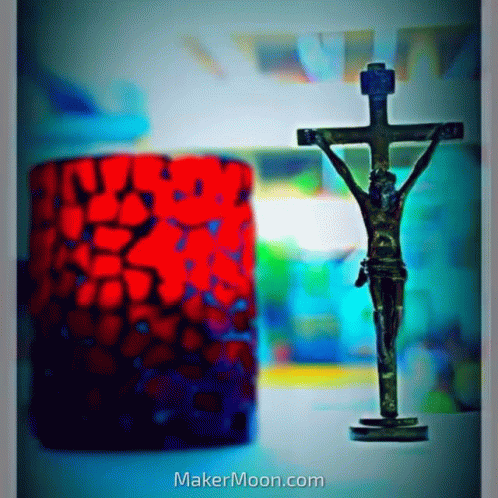 the cross is placed next to a brightly colored lamp