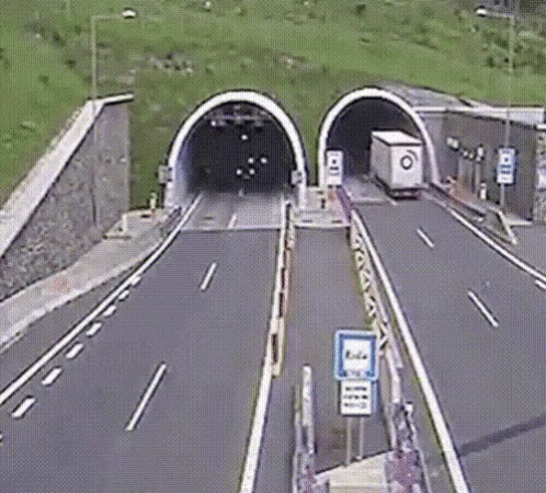 two road tunnel with two cars inside of it
