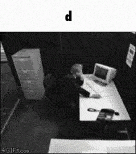 surveillance image of person using computer at work