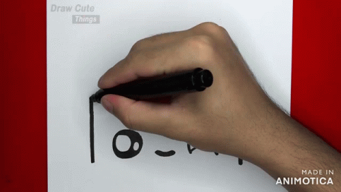 a hand with marker is drawing a face