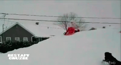 a man is snowboarding down a snowy hill