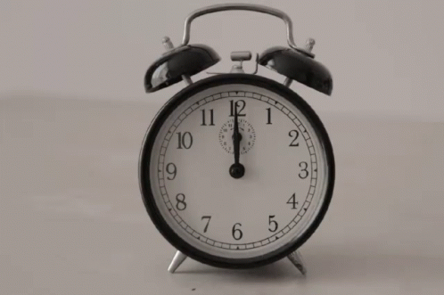 an old - fashioned alarm clock is standing on its side