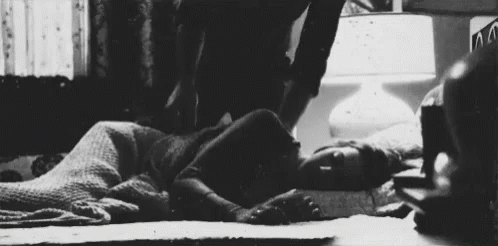 a black and white pograph of a man laying on the ground