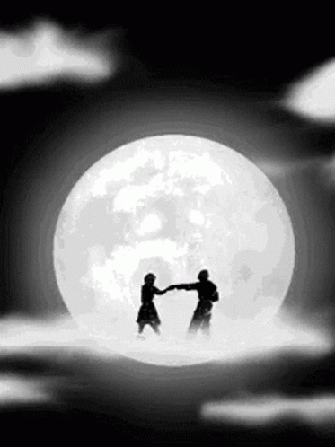 two people shake hands while in front of the full moon