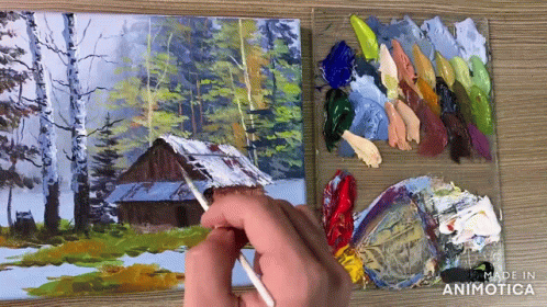 a person painting a picture with colored paint and brush