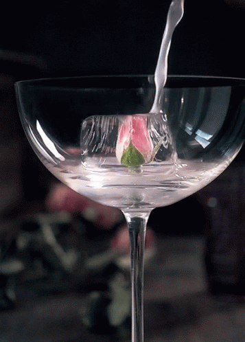 a wine glass is being filled with liquid