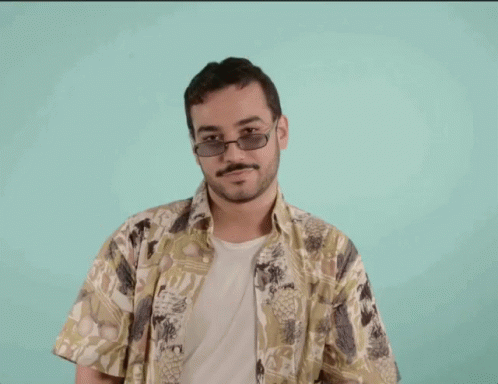 a man with glasses in a blue hawaiian shirt