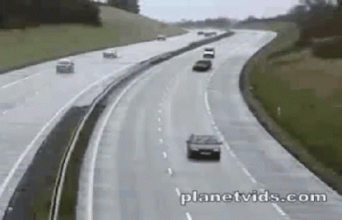 a car driving down the highway with other cars