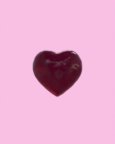 a heart shape glass piece on a lilac background
