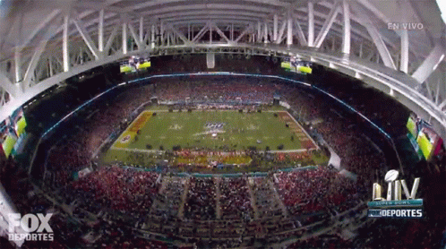 a large stadium full of people during a football game