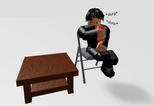 a table and a robot sitting in a chair