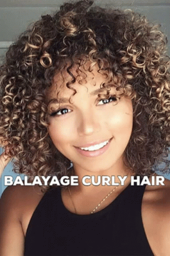an image of a smiling woman with curly hair