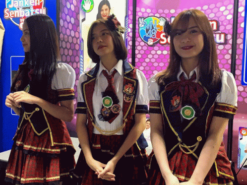 three s are standing beside each other in uniforms