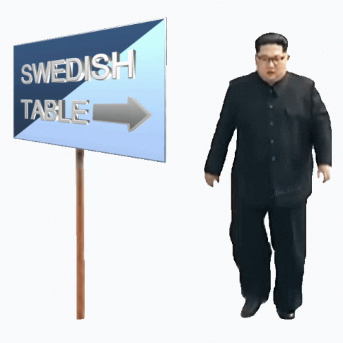a man standing next to a sign that reads swedish table